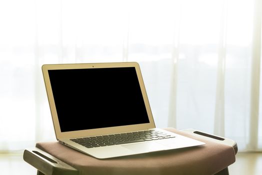 laptop computer and white curtains in bedroom. technology concept, freelance concept, business concept. Selective focus.
