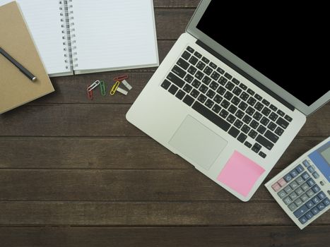 notebook, laptop,Calculator on desk. working concept