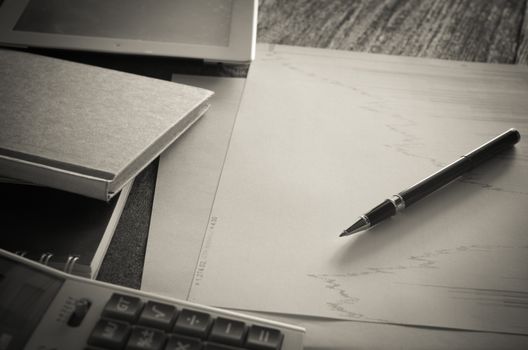 Work table with graph pad and a pen with a calculator.business concept ,style Vintage.