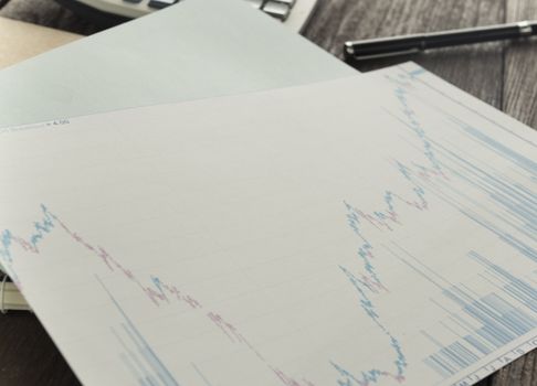 Work table with graph pad and a pen with a calculator.business concept.