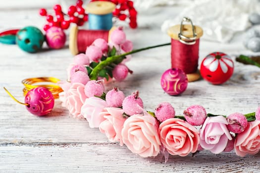 Beads,thread and other sewing accessories in the manufacture of ornaments wreath on his head