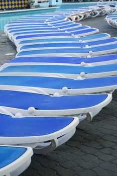 Long row of Empty Sunbeds by pool