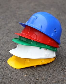 a pile of different colored helmets close up