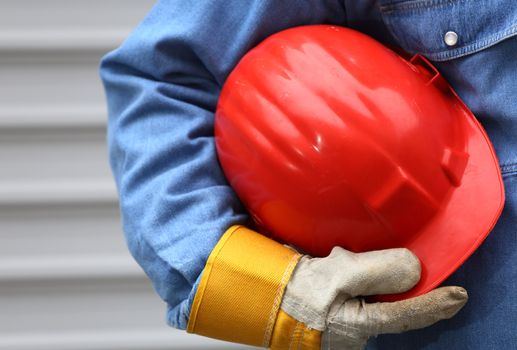 Man holding red helmet close up, shallow dof