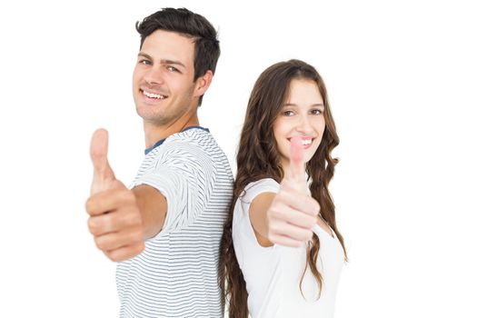 Couple standing back to back with thumbs up on white background
