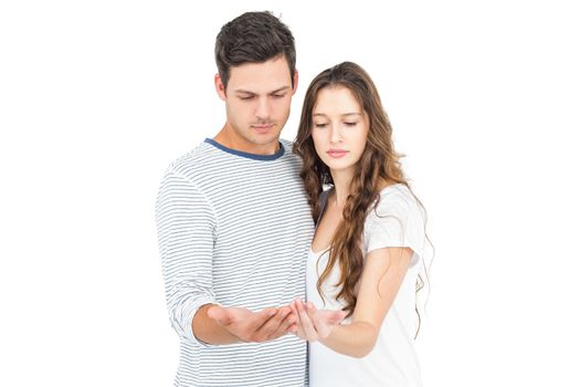 Couple standing with empty hands on white background