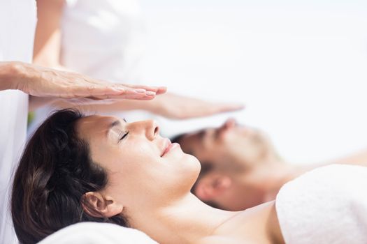 Couple receiving a head massage from masseur in a spa