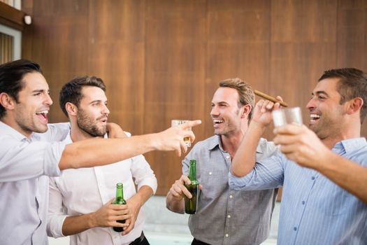 Group of young men having drinks at the party