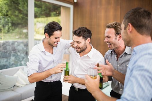 Group of young men having drinks at the party