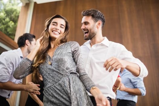 Group of young friends dancing at the party