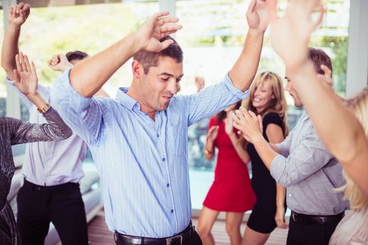 Group of young friends dancing at the party