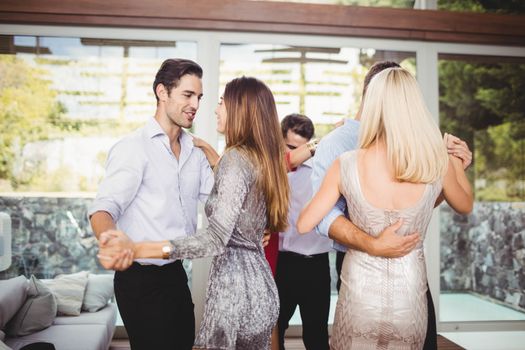 Group of young friends dancing at the party