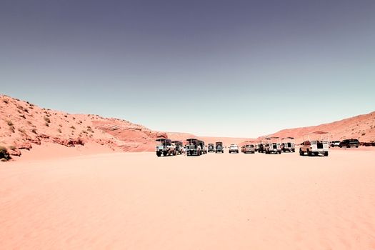 cars park on the sand at Antelope Canyon, USA in summer