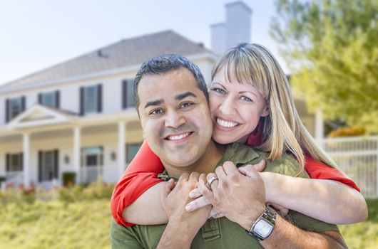 Happy Mixed Race Couple in Front of Beautiful House.