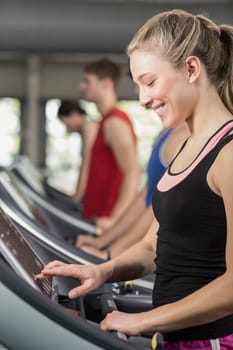 Fit woman running on treadmill at the gym