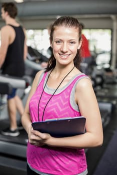 Female trainer smiling to camera in crossfit gym