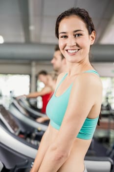 Fit woman running on treadmill at the gym