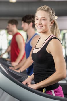 Fit woman running on treadmill at the gym