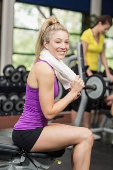 Smiling woman working out in crossfit gym