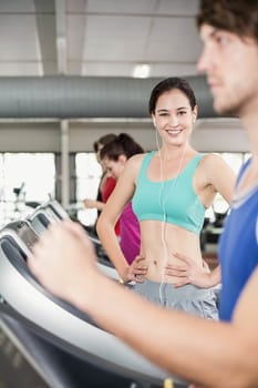 Fit woman running on treadmill at the gym