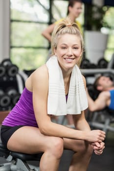 Smiling woman working out in crossfit gym