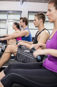 Fit people on drawing machine at gym