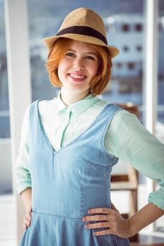 Fashion hipster wearing a hat in front of a window