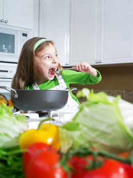 view of young beautiful girl cooking at the kitchen