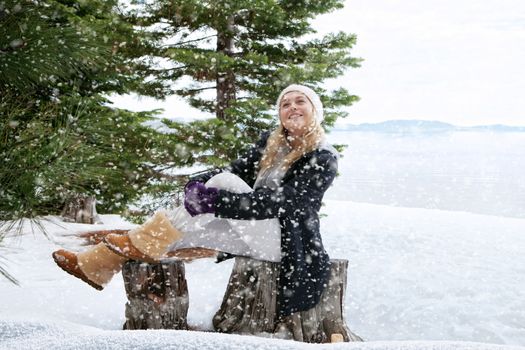 Portrait of young beautiful woman on winter outdoor background