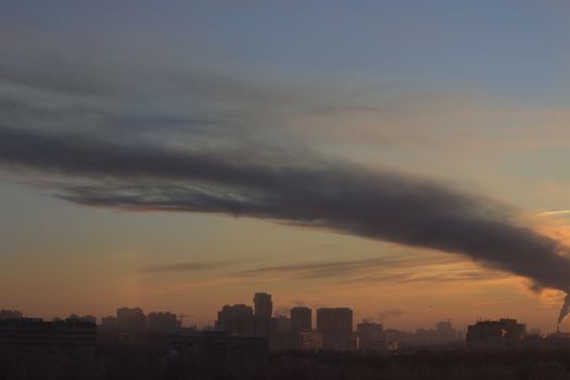 sunset in the city, funnel, smoke, buildings silhouette