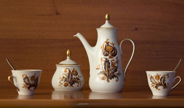 coffee set with brown flowers, on wooden table