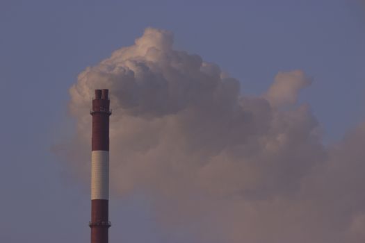 Tube with orange smoke on winter sunset