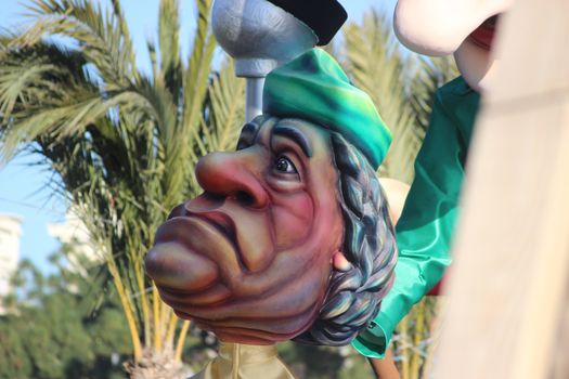 Nice, France - February 21 2016: Caricature of Muammar Gaddafi (Colonel Gaddafi). Parade Float during the Carnival of Nice (Corso Carnavalesque 2016) in French Riviera. The Theme for 2016 was King of Media