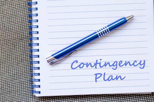 Contingency plan text concept write on notebook with pen