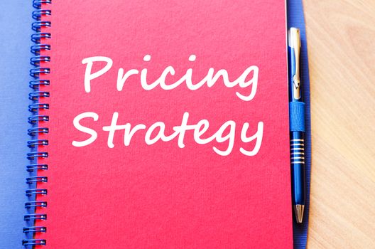 Pricing strategy text concept write on notebook with pen