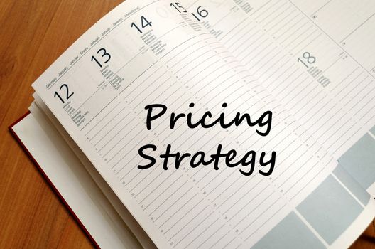 Pricing strategy text concept write on notebook with pen