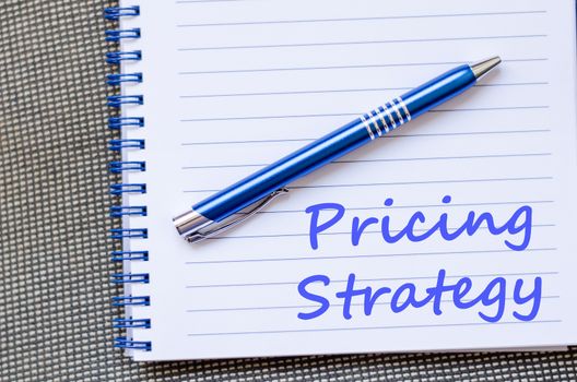 Pricing strategy text concept write on notebook with pen