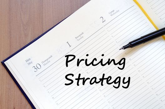 Pricing strategy text concept write on notebook with pen