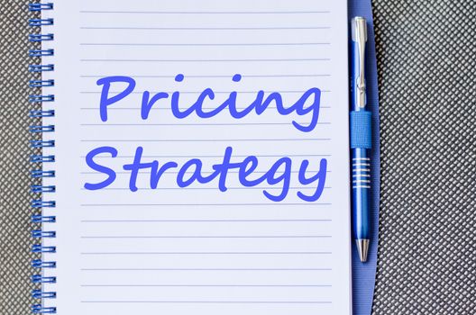 Pricing strategy text concept write on notebook with pen