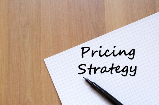 Pricing strategy text concept write on notebook with pen