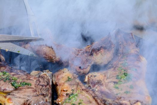 Roast beef, cooked in the outdoor barbecue in a rural location. Sauce: olive oil, salt, parsley.