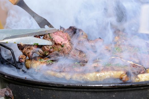 Roast beef, cooked in the outdoor barbecue in a rural location. Sauce: olive oil, salt, parsley.