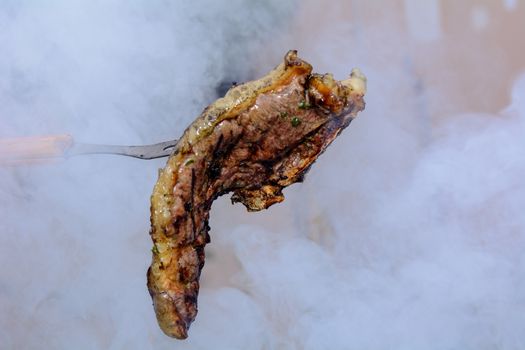 Roast beef, cooked in the outdoor barbecue in a rural location. Sauce: olive oil, salt, parsley.