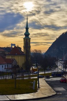 BUDAPEST, HUNGARY - FEBRUARY 02: Sunrise behind clouds over tower of Saint Caitlin of Alexandria Temple. February 02, 2016 in Budapest.