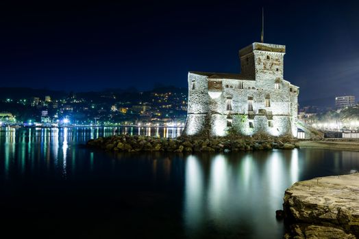 The ancient castle of Rapallo, built on the ligurian sea illuminated by night.