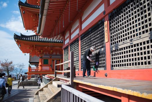 Kyoto, Japan - November 6, 2015: Old man cleaning and maintenance at Kiyomizu-dera temple in Kyoto, Japan