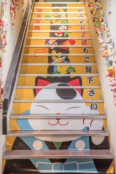 Kyoto, Japan - November 6, 2015: Paint of Maneki Neko Cat to welcome tourist. Japanese sculpture bring good luck to the owner.