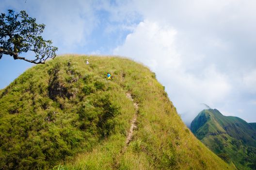 Mountaineer tourists hiking on (Khao Chang Puak) of mountains at Kanchanaburi, Thailand.