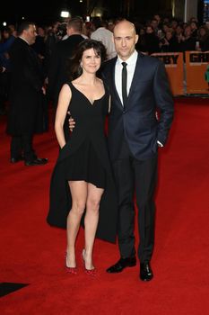 UK, London: Liza Marshall and Mark Strong pose on the red carpet after arriving to attend the World Premiere of the film Grimsby, in London on February 22, 2016.