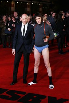 UK, London: British actor Sacha Baron Cohen (R) and Mark Strong pose on the red carpet after arriving to attend the World Premiere of his latest film, Grimsby, in London on February 22, 2016.